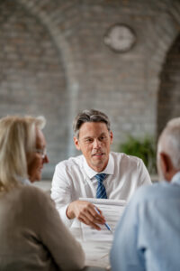 man consulting with older couple