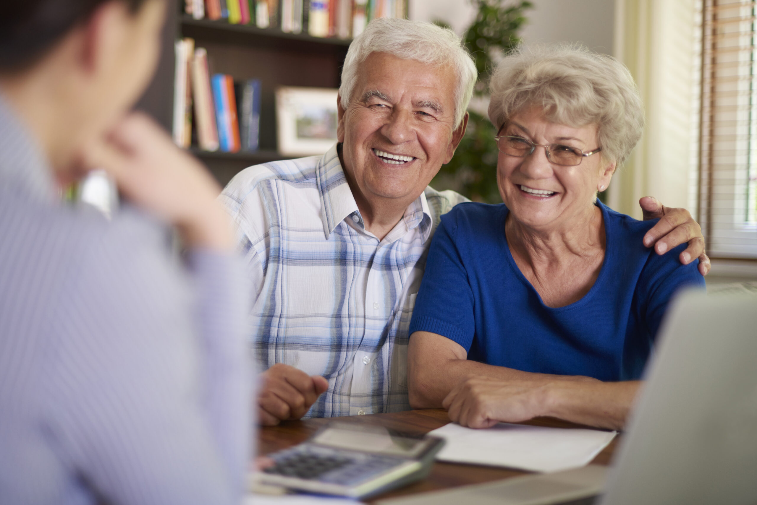 medicare consultant talking with a senior couple