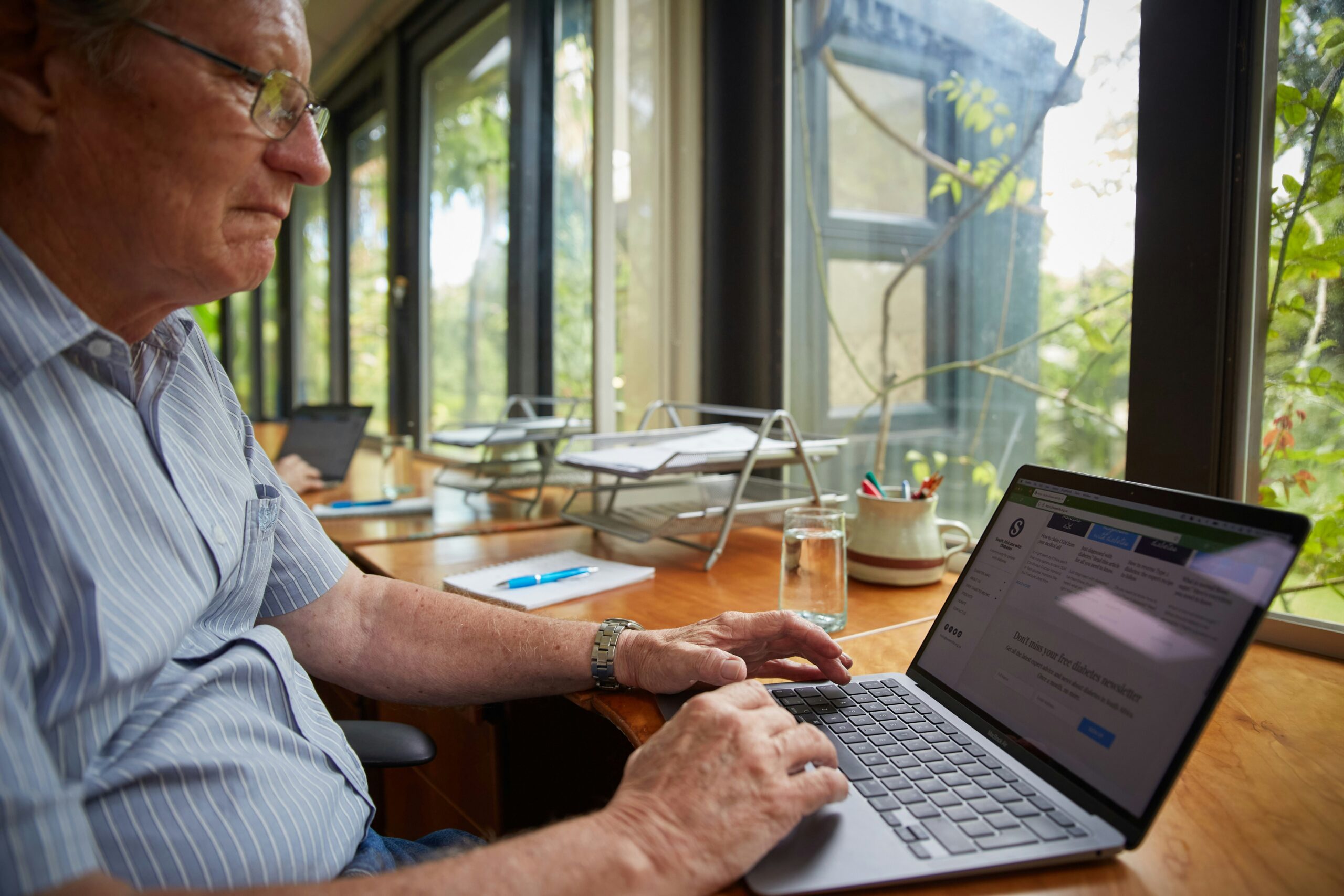 OLD man working on a computer